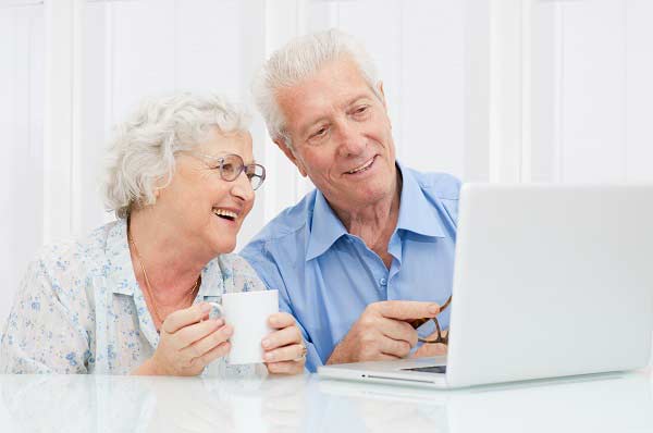 elderly couple with laptop computer