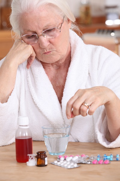Elderly lady with her medication