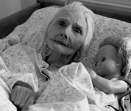 elderly woman in nursing home bed