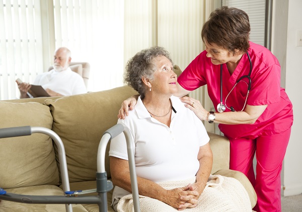 nurse and elderly patient in nursing home