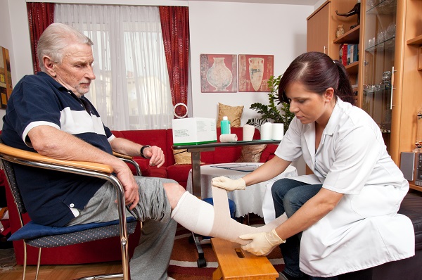 nurse caring for elderly man