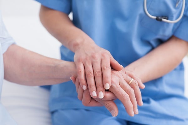 doctor touching a patient's hand
