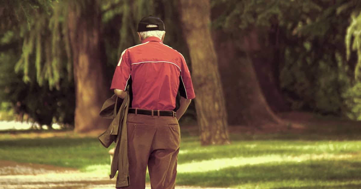 elderly man walks alone by trees | Boller and Vaughan